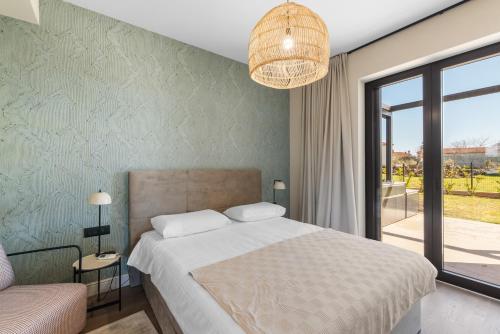 En eller flere senge i et værelse på Villa Maria