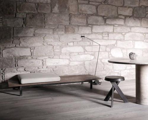 a bench and a table in a room with a brick wall at Luxury lodge for 16 in Royal Deeside in Ballater