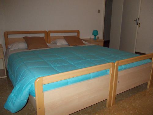a bedroom with a bed with a blue comforter at Big Brother Bed & Rooms in Treviso