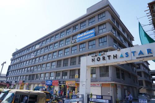a large building with a northstar sign in front of it at City Dormitory in Ahmedabad