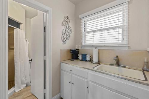 a kitchen with a sink and a window at 118 Emerald Ave A & B in Newport Beach