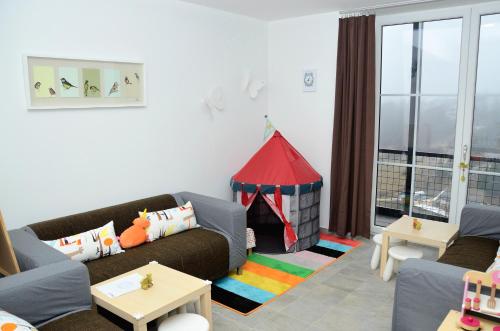 a living room with a couch and a play tent at Penzion Na Vršku in Branná