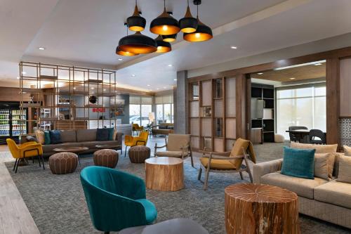 a lobby with couches and chairs and tables at TownePlace Suites by Marriott Albuquerque Uptown in Albuquerque