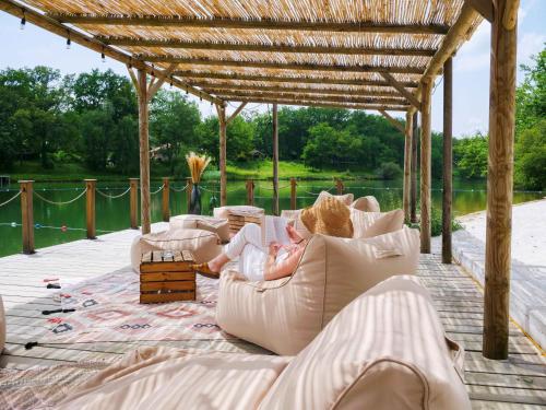 a baby laying on a couch under a pergola at Whaka Lodge in Seissan