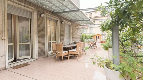 a patio with a table and chairs on it at Classbnb - Two apartments 400 meters from the Duomo in Milan