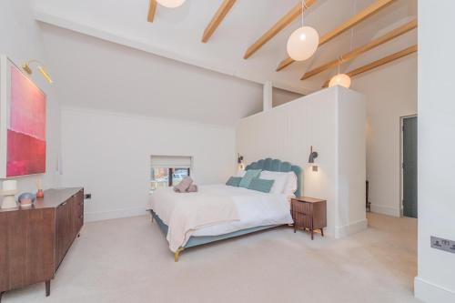 a bedroom with a bed and a dresser at Tackroom Great Ness Shrewsbury in Great Ness