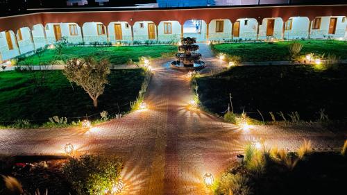 a view of a courtyard at night with lights at Hotel Meteorites Boulaajoul in Zaida