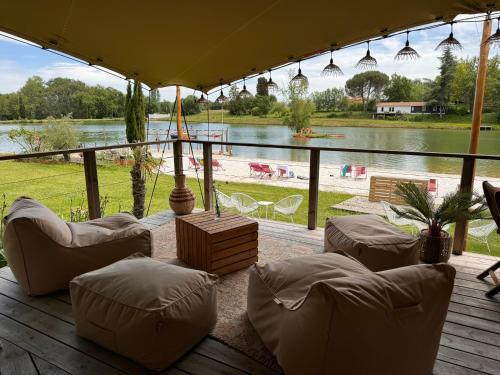 a patio with chairs and a view of a lake at Whaka Lodge in Seissan