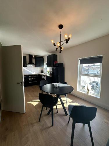a living room with a table and chairs and a bedroom at Abbey Apartments in Dublin