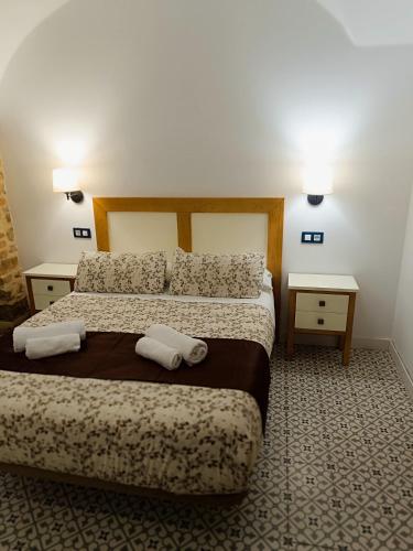 Katil atau katil-katil dalam bilik di Al-Qazeres Suites