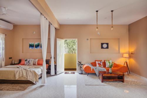 Moonlight Manor- Luxury Escape في بانغالور: غرفة نوم بها سرير وأريكة