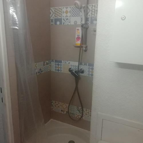 La salle de bains est pourvue d'une douche et d'une raquette de tennis. dans l'établissement studio, au Grau-du-Roi