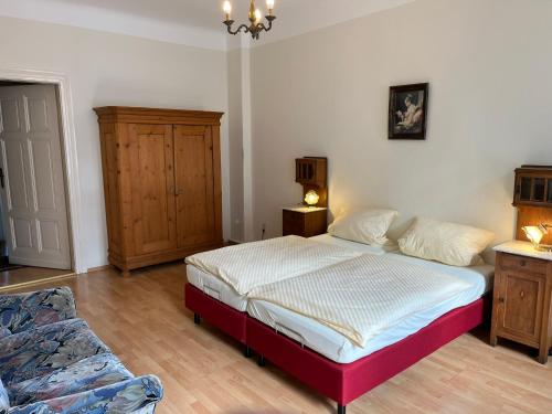 a bedroom with a bed and a dresser at Haus Gründerzeit in Görlitz