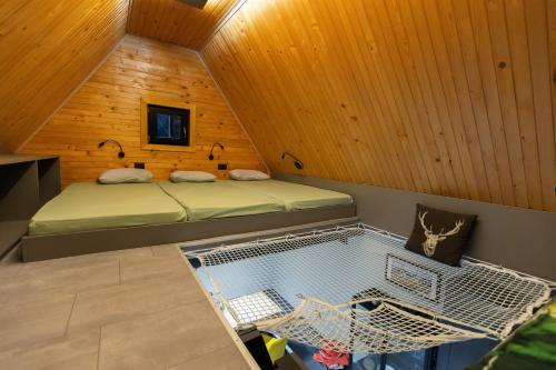 a small room with two beds in a cabin at Pine Hill RUBY in Rakitna