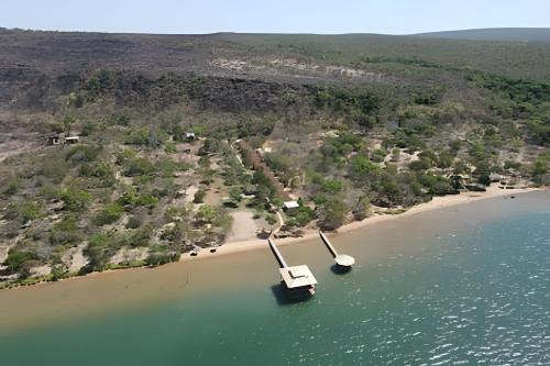 two boats in the water next to a beach at Pousada Cocobeach Adventure - Miracema do Tocantins in Palmas