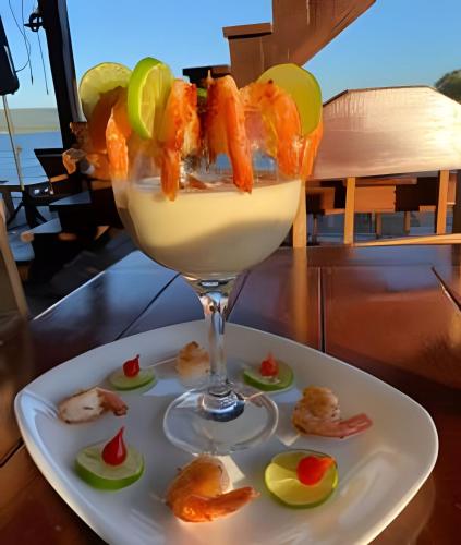 a drink with shrimp on a plate on a table at Pousada Cocobeach Adventure - Miracema do Tocantins in Palmas