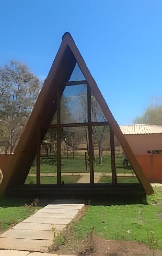 a triangle shaped building with windows in a park at Pousada Cocobeach Adventure - Miracema do Tocantins in Palmas