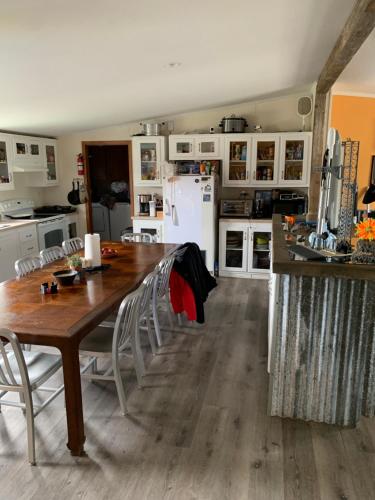 a kitchen with a wooden table and white appliances at Rocket Ranch #1 - Mars in Brownsville