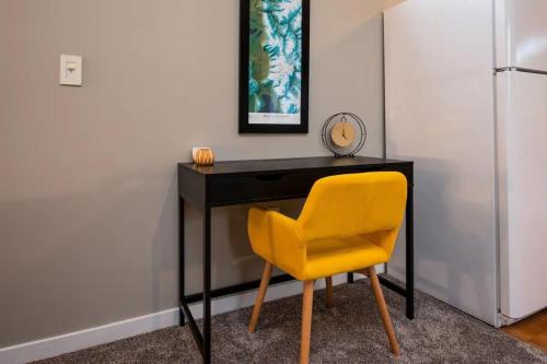 a desk with a yellow chair in a room at Upper Mountain Haus Studio Close to Slopes Mtns in Ogden