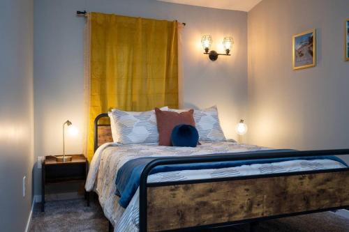 a bedroom with a bed with a yellow curtain at Upper Mountain Haus Studio Close to Slopes Mtns in Ogden