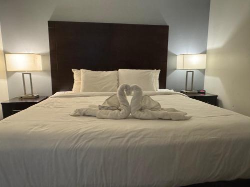 two towel animals sitting on top of a bed at Clarion Inn & Suites Dothan South in Dothan