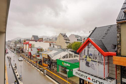 a city with a flooded street and buildings at Gray Fox Apartments - San Martin in Ushuaia