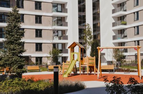 a playground in front of a apartment building at Premium Planet Deluxe in Niš