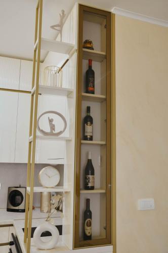a cabinet filled with bottles of alcohol in a kitchen at Premium Planet Deluxe in Niš