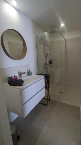 a white bathroom with a sink and a shower at Tropical Haven 2 pieces contemporain avec piscine in Les Trois-Îlets