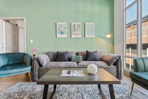 a living room with a couch and a coffee table at Uptown Luxury - Top Floor King Suite, Free Parking in Charlotte