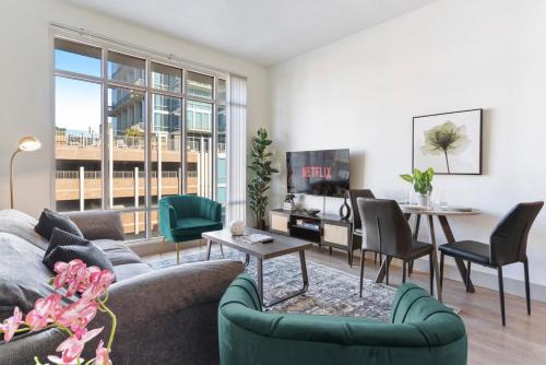 a living room with a couch and a table at Uptown Luxury - Top Floor King Suite, Free Parking in Charlotte