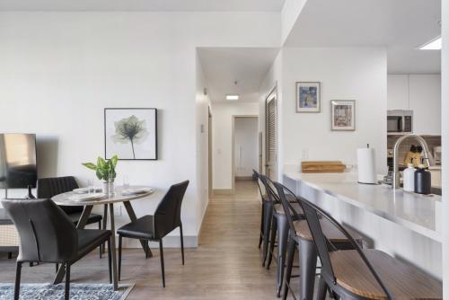 a kitchen and dining room with a table and chairs at Uptown Luxury - Top Floor King Suite, Free Parking in Charlotte