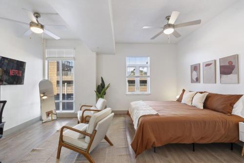 a bedroom with a bed and a ceiling fan at Uptown Luxury - Top Floor King Suite, Free Parking in Charlotte
