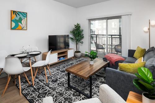 a living room with a couch and a table at Urban Retreat - Free Parking, WiFi, Walk to Stadium in Charlotte