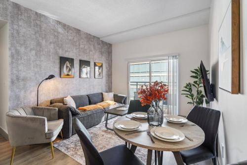 a living room with a table and a couch at Queen City Retreat - Parking, Views, Near Stadium in Charlotte