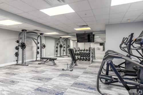 a gym with treadmills and weights at Queen City Retreat - Parking, Views, Near Stadium in Charlotte