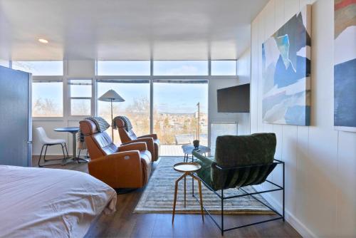a bedroom with a bed and two chairs and a table at Iconic Modern Stay w Free Parking in Spokane