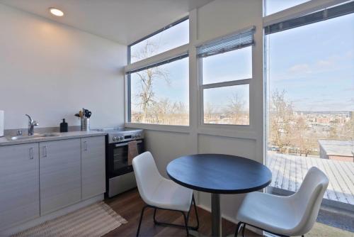 a kitchen with a table and chairs and a window at Iconic Modern Stay w Free Parking in Spokane