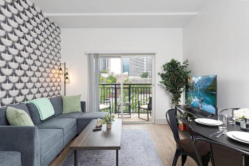 a living room with a couch and a table at The Tar Heel - Stylish 4BR with City Views - Free Parking - Gym in Charlotte