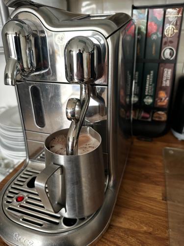 a coffee machine with a coffee being poured into it at Chez Ana in Saxmundham