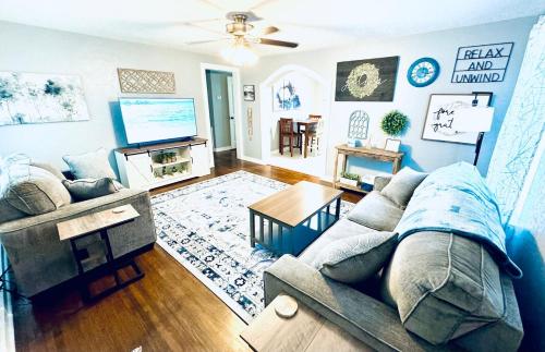 a living room with a couch and a tv at Relax & Unwind in 2BR 1BA Home in Quiet Neighborhood in Nederland