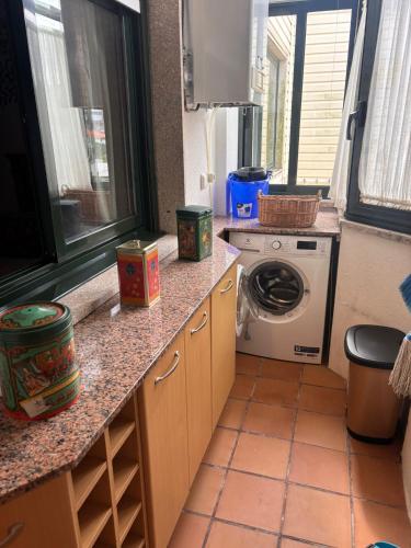 a kitchen with a washing machine on a counter at Duplex Bueu Vistas con terraza in Bueu