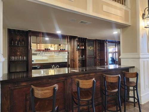 a bar with wooden stools in a room at Historic Griffin Hotel in Griffin