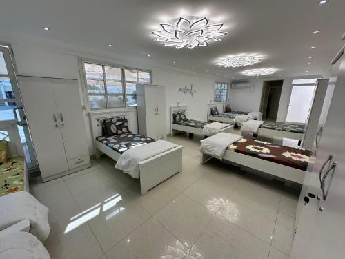 a large room with two beds and a table at International Abu Dhabi Hostel in Abu Dhabi