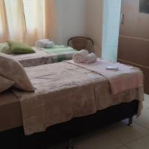 a bedroom with two beds with towels on it at Pousada do Trinta in Fernando de Noronha