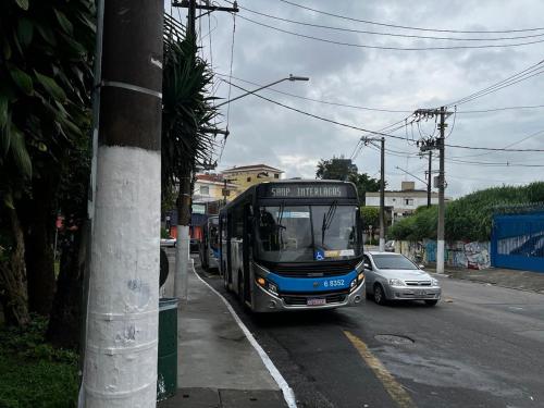a bus parked on the side of a street at Condomínio Residencial Vitória 3 in Sao Paulo