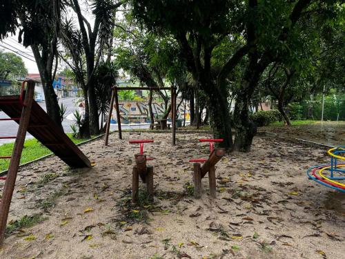 a park with a swing set and a playground at Condomínio Residencial Vitória 3 in Sao Paulo