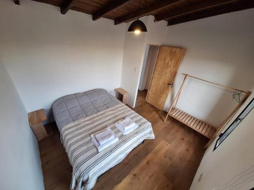 a bedroom with a bed with two pillows on it at Casa BAO in Río Gallegos