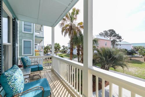 a balcony with chairs and a view of the ocean at Rolling Tide - Short Walk to the Beach in Cedar Reef Villas