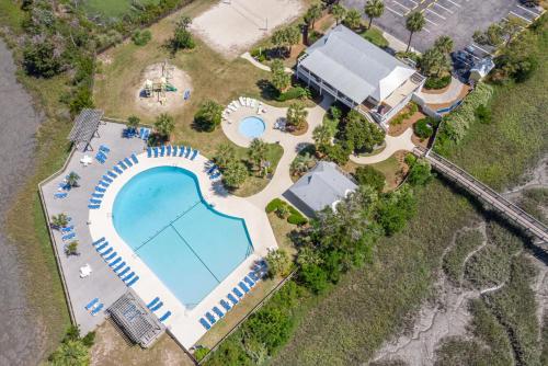 an overhead view of a swimming pool and a house at Rolling Tide - Short Walk to the Beach in Cedar Reef Villas